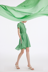 a lady in green silk dress with a piece of green silk fabric